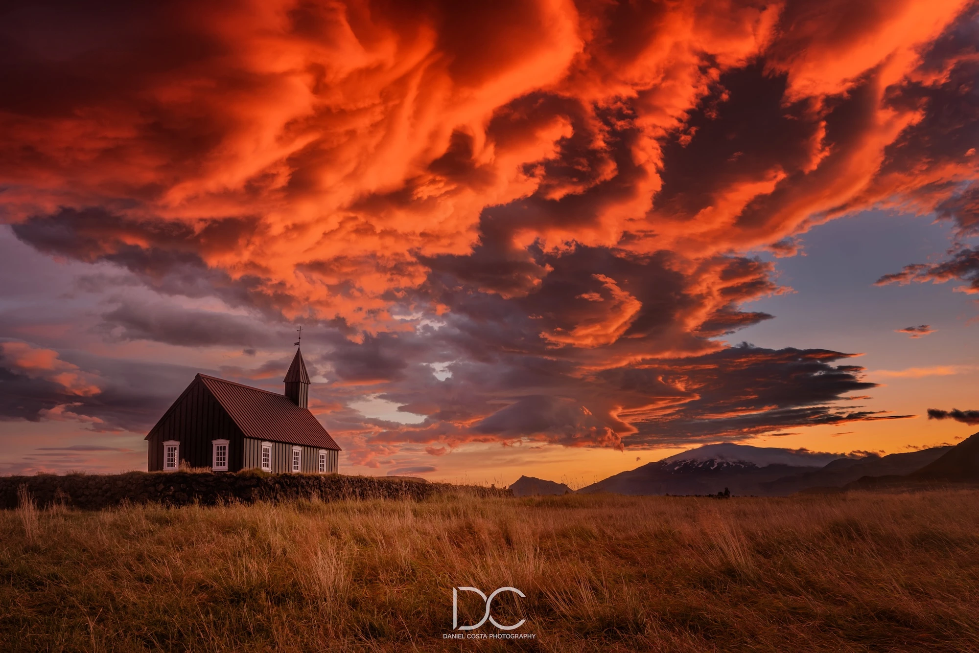 Wheat field with the house and dramatic red sky