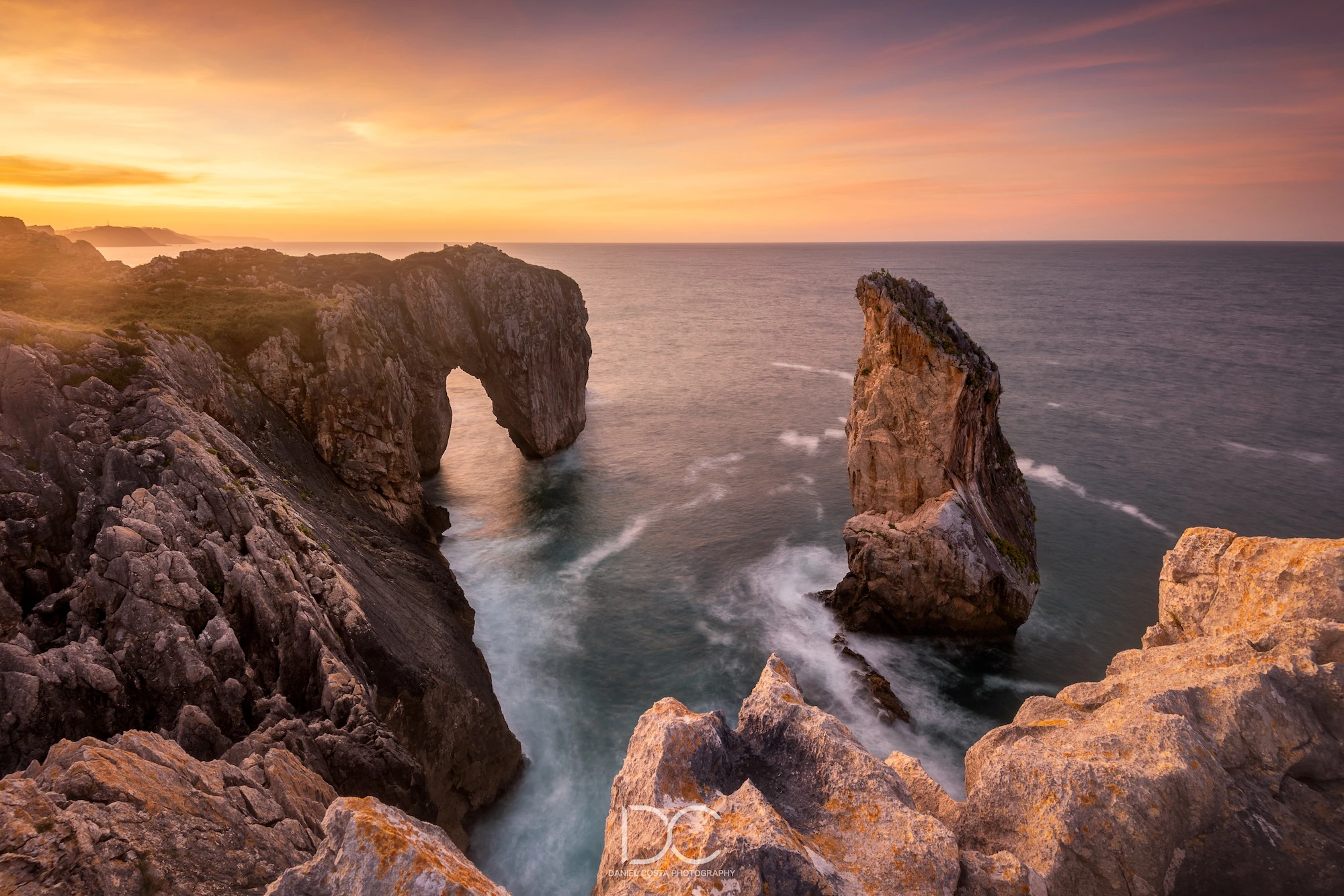 Seascape with rocks and sun